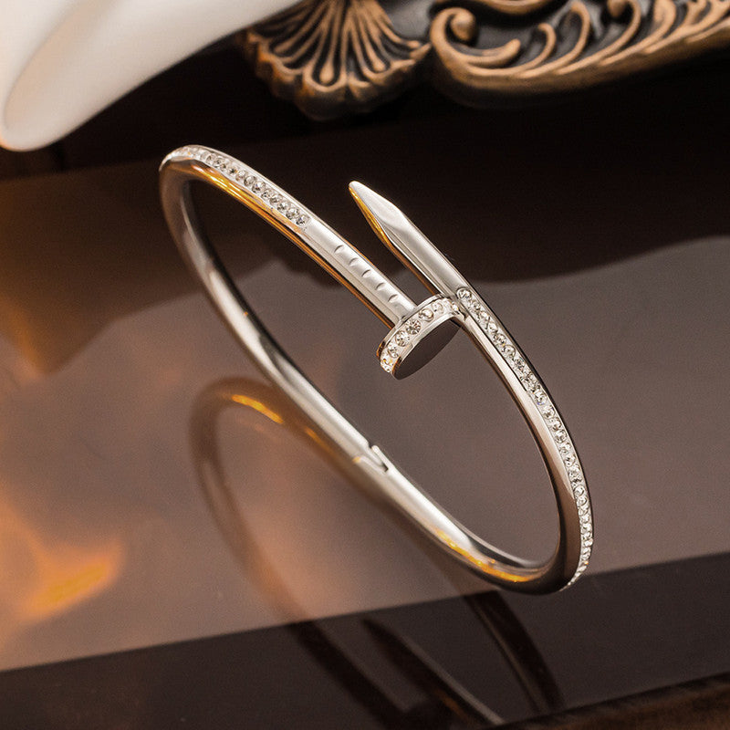Jewels Galaxy Stainless Steel Anti Tarnish AD Studded Nail Bracelet For Women