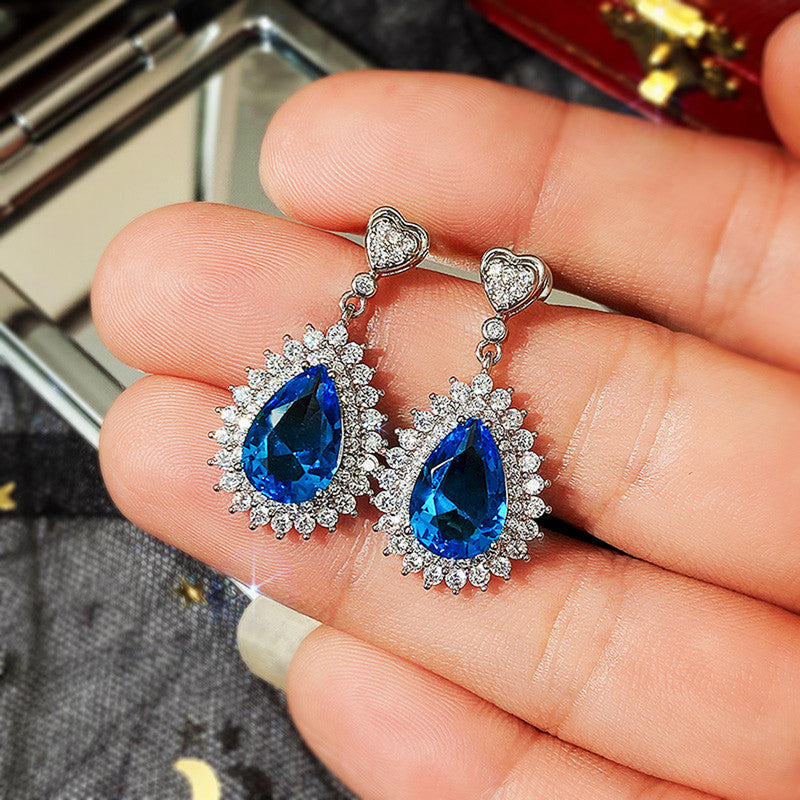 Jewels Galaxy Silver Plated American Diamond Studded Blue Teardop Shape Ice Cut Drop Earrings