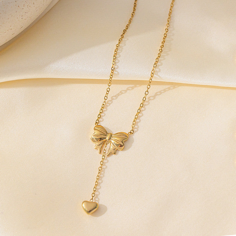 Jewels Galaxy Gold Plated Stainless Steel Anti Tarnish Heart Themed Bow inspired Pendant Necklace