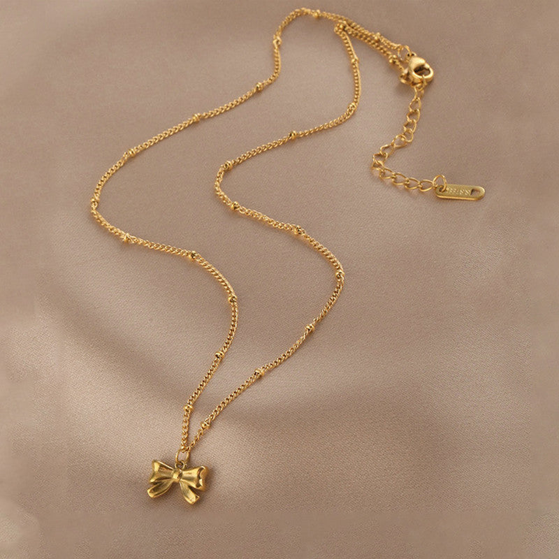 Jewels Galaxy Gold Plated Stainless Steel Anti Tarnish Bow Themed Pendant