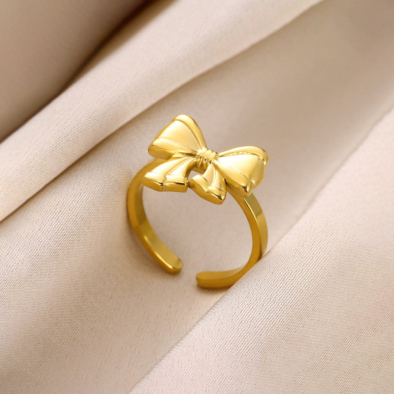 Jewels Galaxy Gold Plated Stainless Steel Anti Tarnish Bow Themed Adjustable Finger Ring For Women