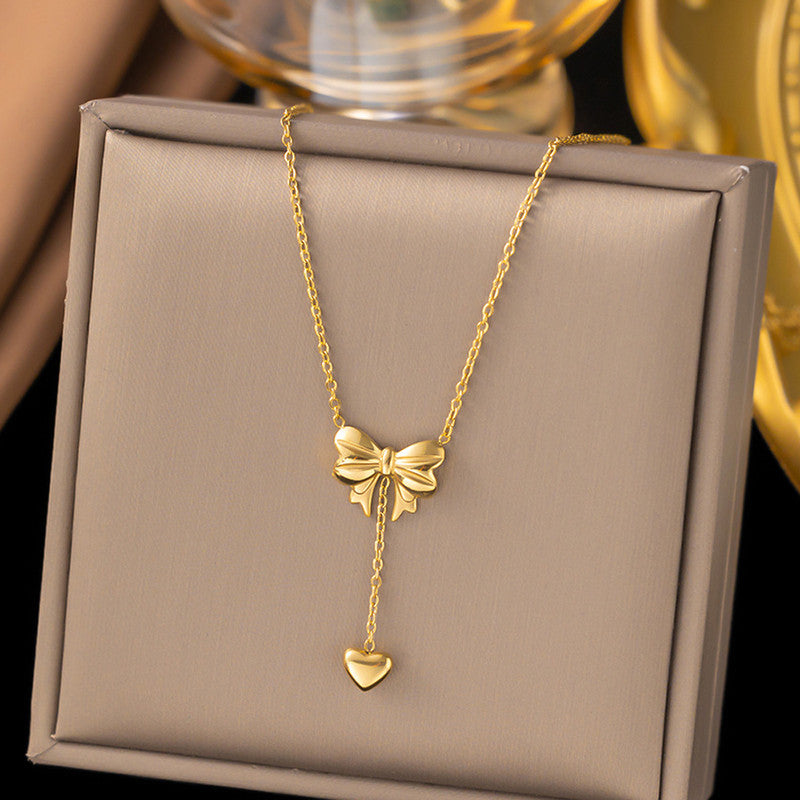 Jewels Galaxy Gold Plated Stainless Steel Anti Tarnish Heart Themed Bow inspired Pendant Necklace