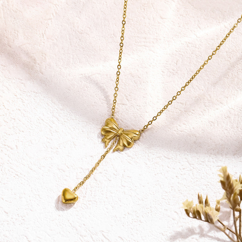 Jewels Galaxy Gold Plated Stainless Steel Anti Tarnish Heart Themed Bow inspired Pendant Necklace