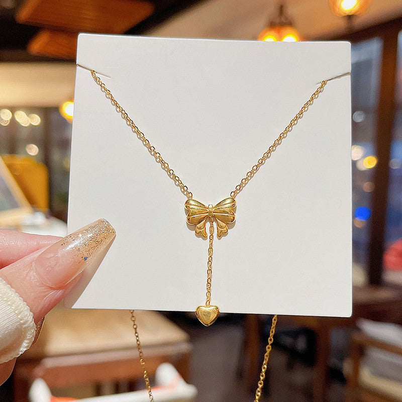 Jewels Galaxy Gold Plated Stainless Steel Anti Tarnish Heart Themed Bow inspired Pendant Necklace