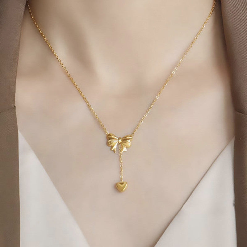 Jewels Galaxy Gold Plated Stainless Steel Anti Tarnish Heart Themed Bow inspired Pendant Necklace