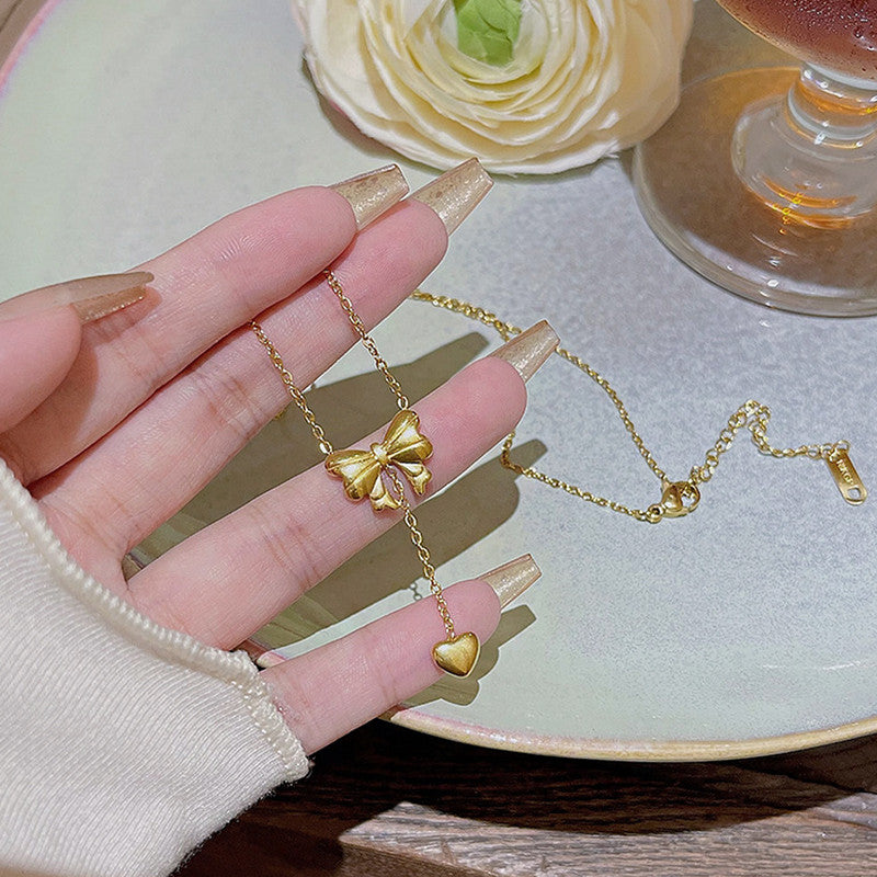 Jewels Galaxy Gold Plated Stainless Steel Anti Tarnish Heart Themed Bow inspired Pendant Necklace