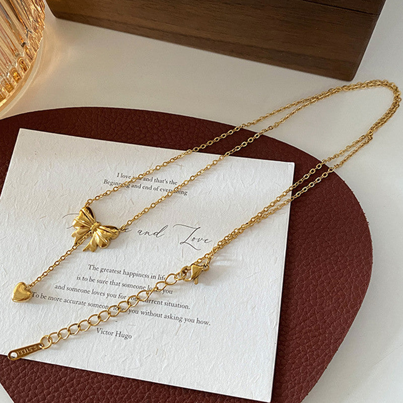 Jewels Galaxy Gold Plated Stainless Steel Anti Tarnish Heart Themed Bow inspired Pendant Necklace