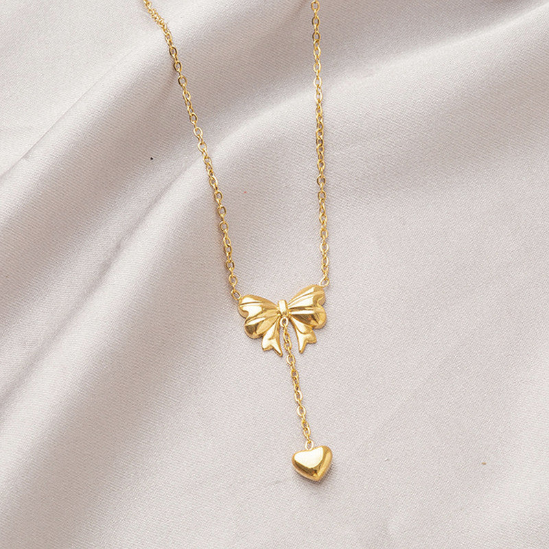 Jewels Galaxy Gold Plated Stainless Steel Anti Tarnish Heart Themed Bow inspired Pendant Necklace
