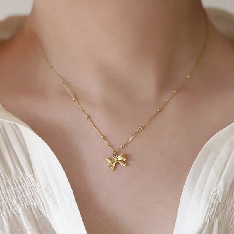 Jewels Galaxy Gold Plated Stainless Steel Anti Tarnish Bow Themed Pendant