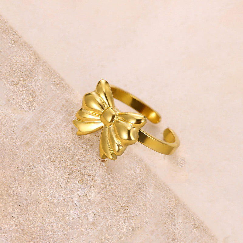 Jewels Galaxy Gold Plated Stainless Steel Anti Tarnish Bow Themed Adjustable Finger Ring For Women