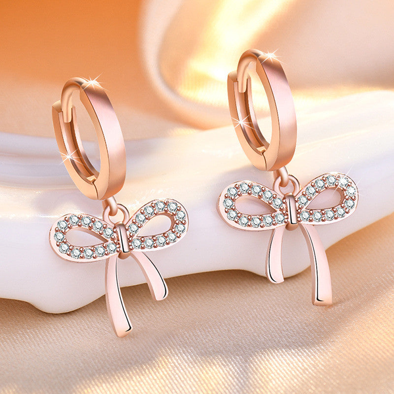 Jewels Galaxy Rose Gold Plated American Diamond Studded Bow-Tie Shape Korean Stud Earrings